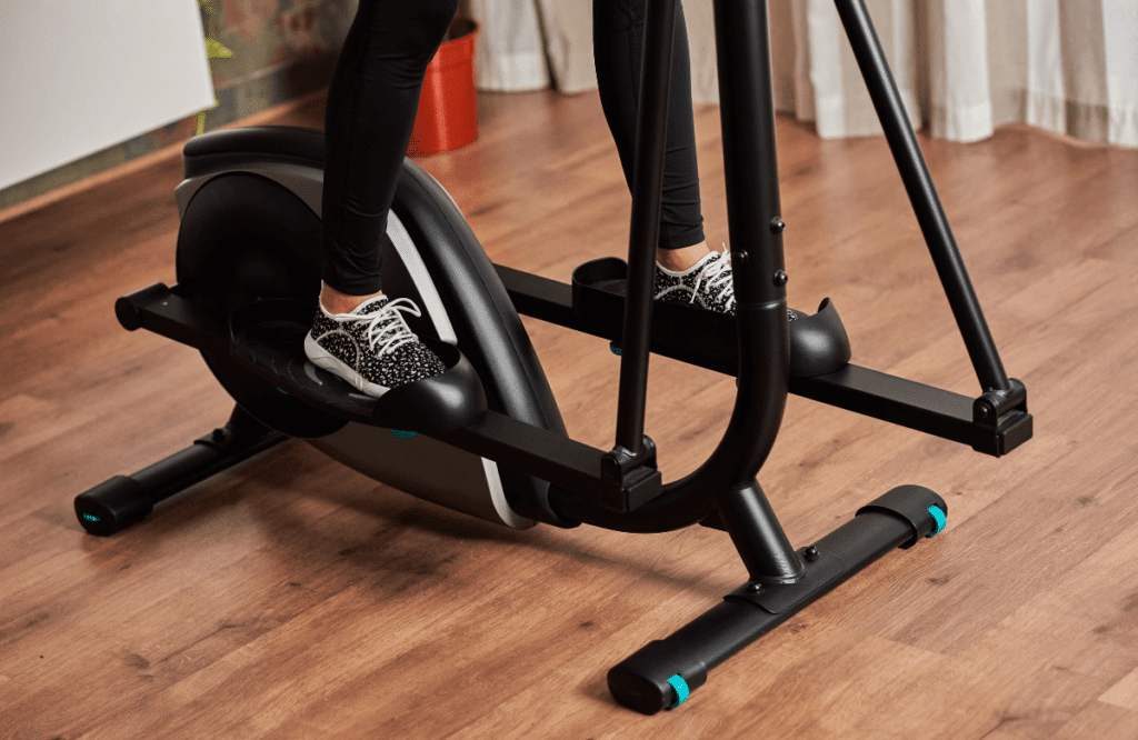 A woman using the best elliptical for apartment at home