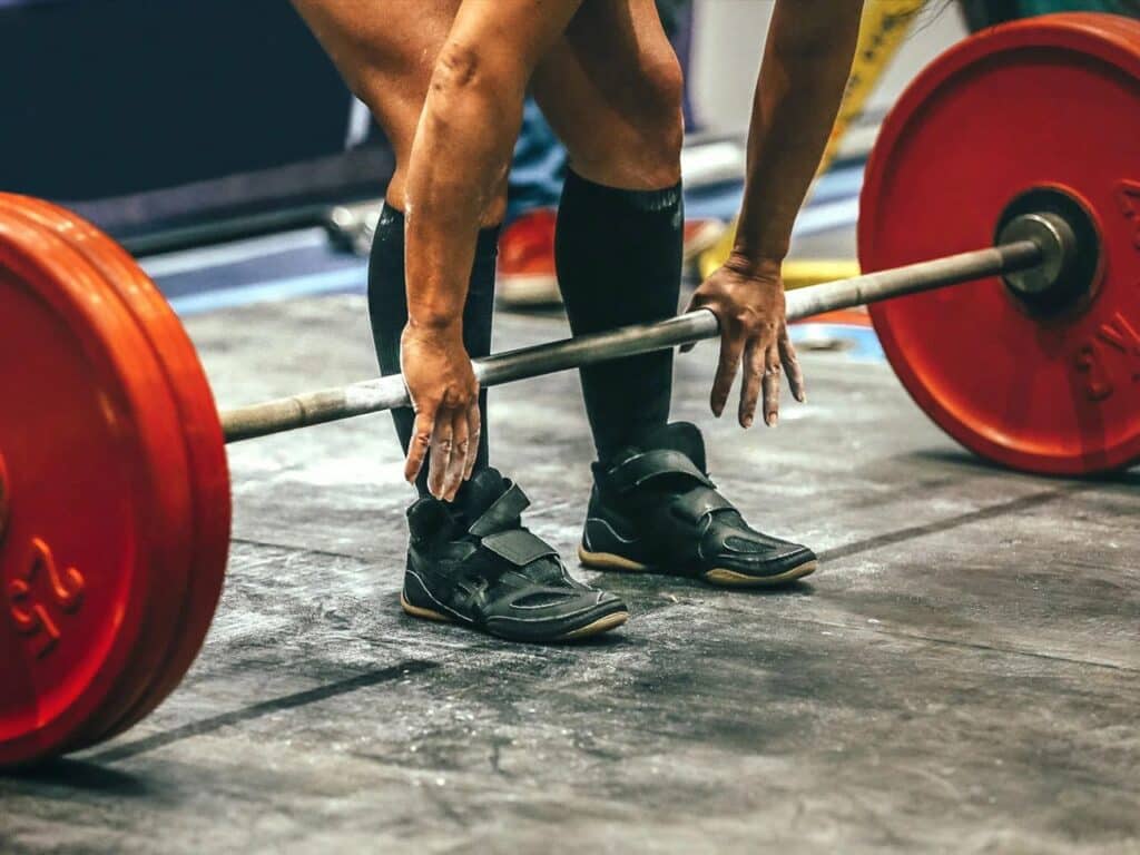 A man preparing banded deadlifts during a competition