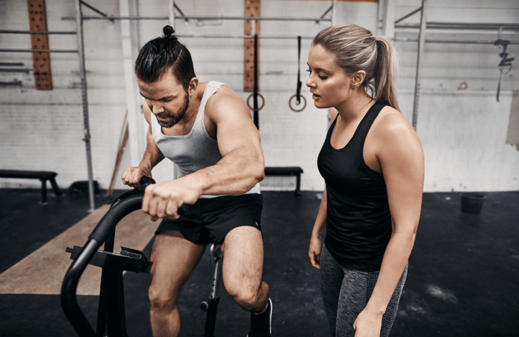 A man and his coach using the best elliptical bike