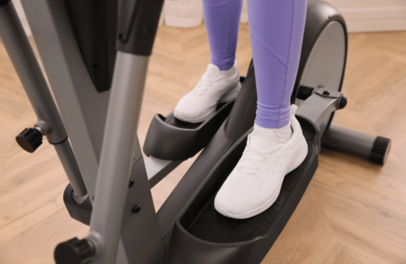 A woman using the best compact elliptical at home