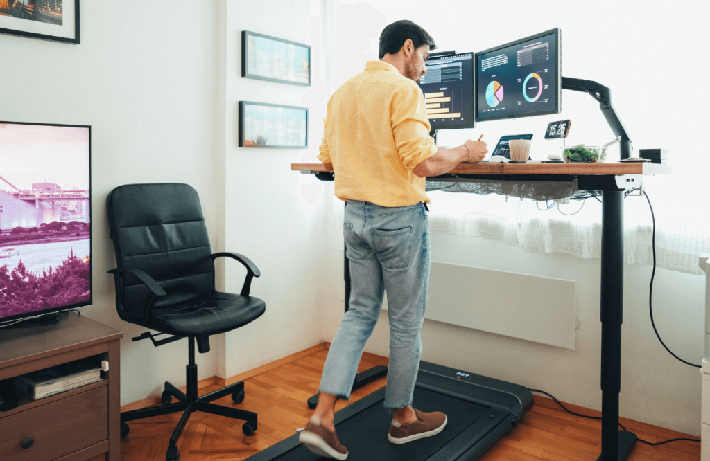 A man working at home using the best under-desk treadmill