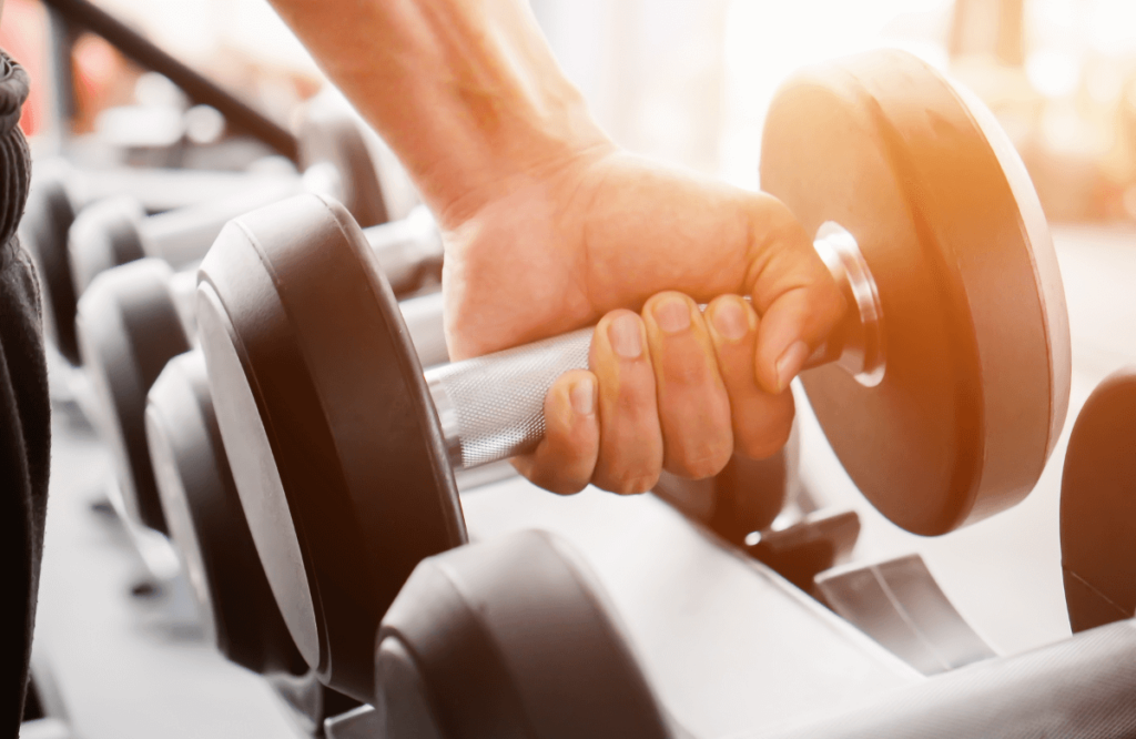 A man doing dumbbell pullovers after listening to advice