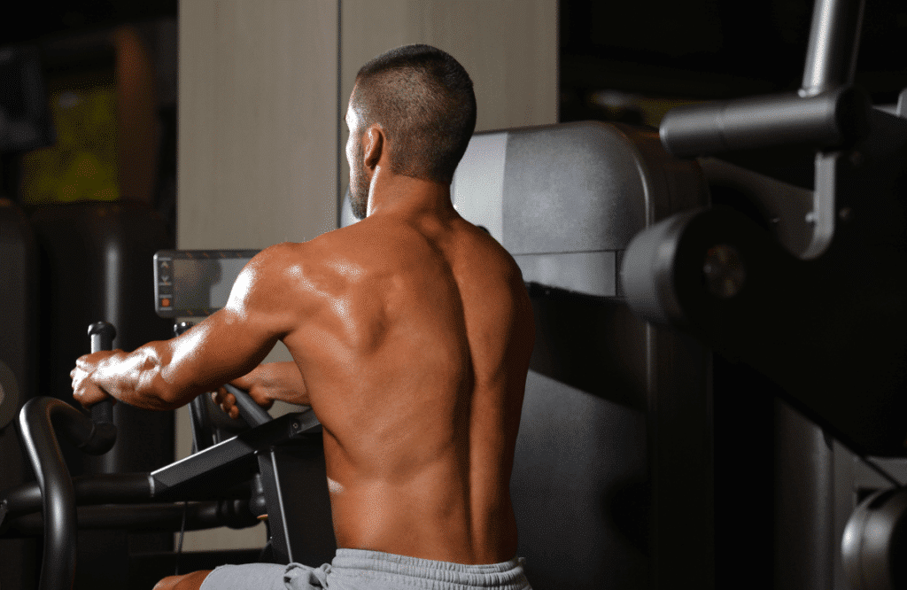 A man working out his back using a low row machine