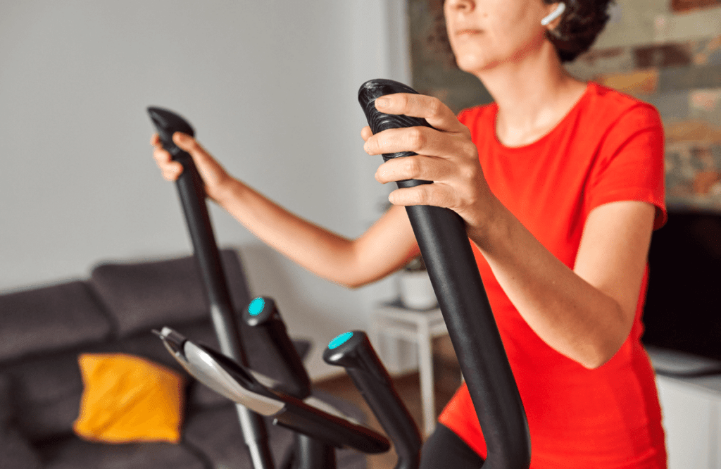 A woman using the best foldable treadmill in her living room
