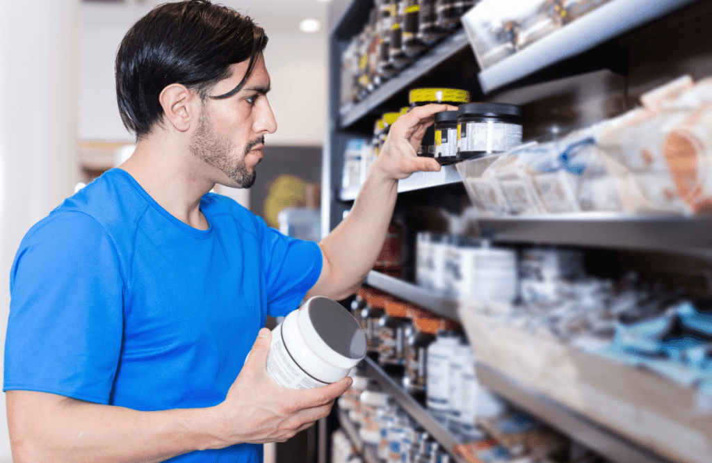 A man picking a box of the best cheap pre-workout