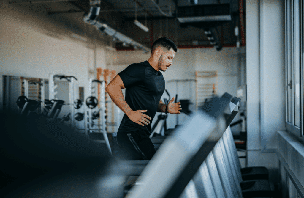 A man calculating the mileage on his treadmill