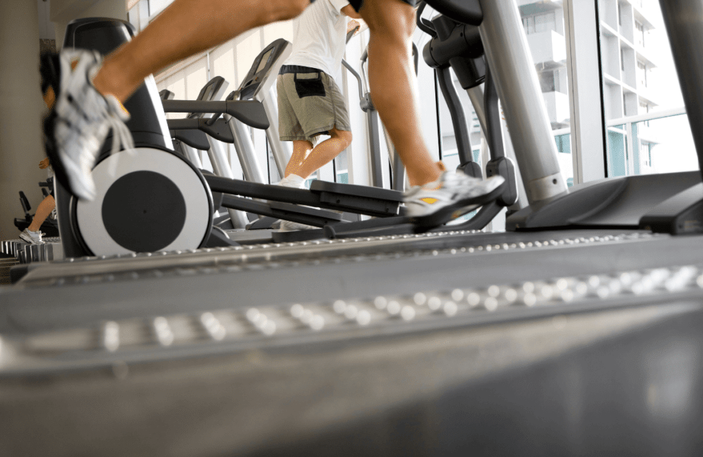 A man running on a treadmill at the gym