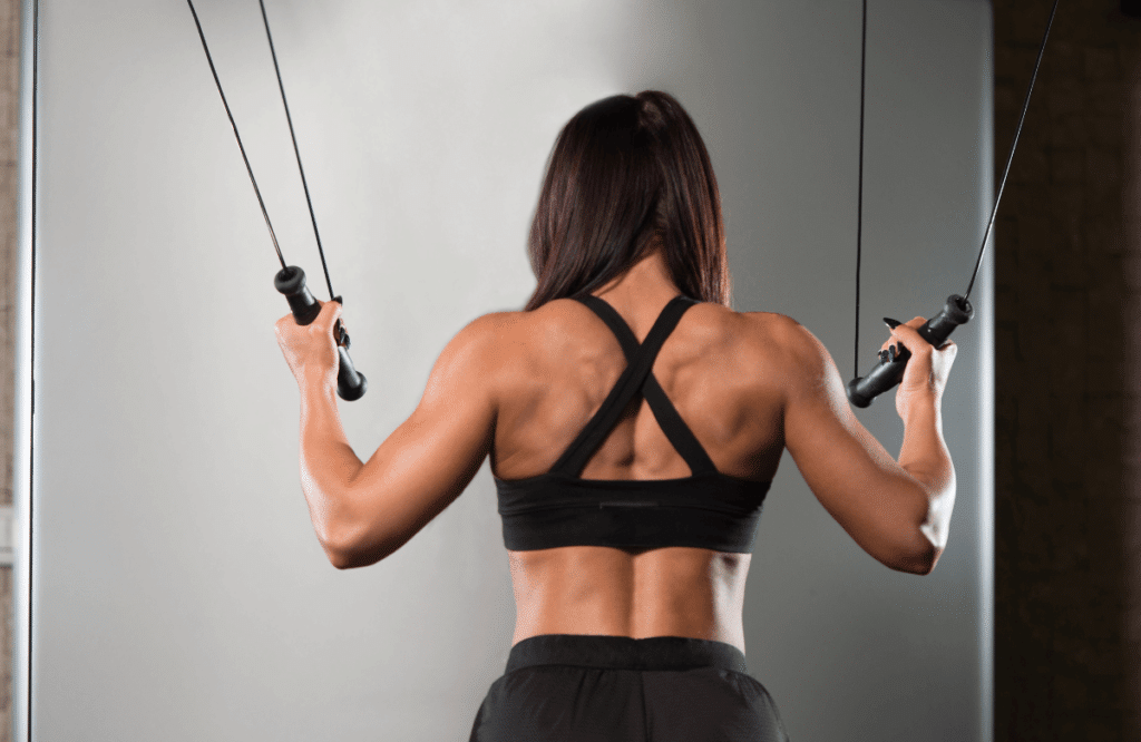 A woman doing cable back workouts