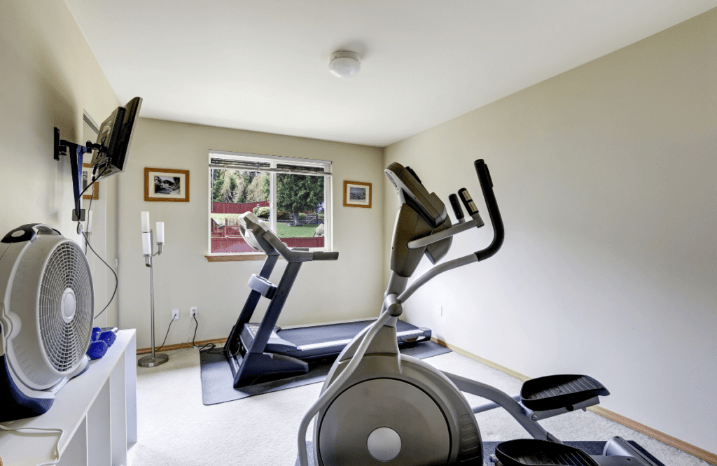 A home gym with a treadmill