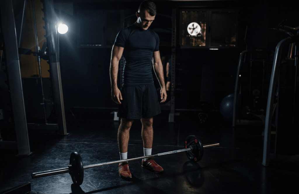 A beginner at the gym preparing his workout sessions with the best deadlift routine