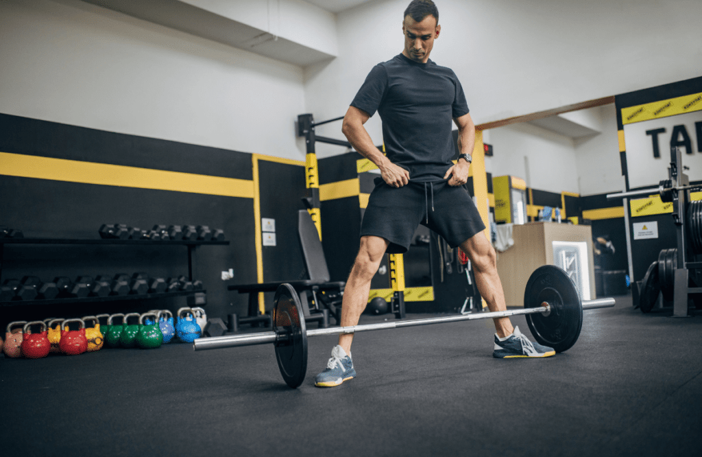 A man at the gym adjusting his deadlift program