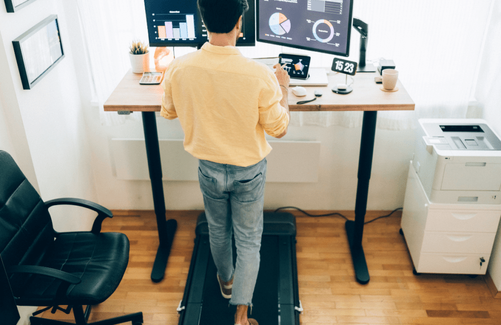 A serious man walking on the best under-desk treadmill at home