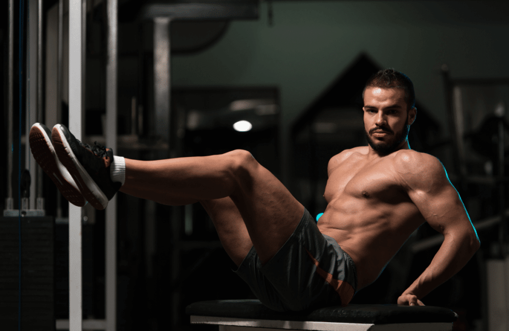 A man doing oblique crunches at the gym