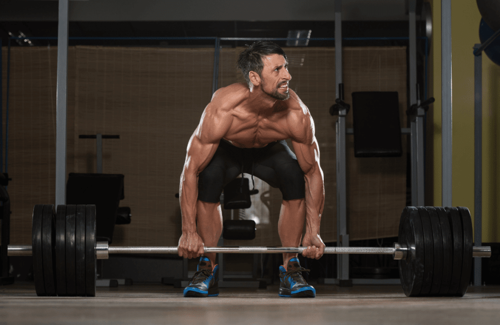 A man preparing to deadlift at the gym