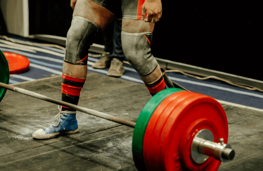 A powerlifter about to deadlift in a competition