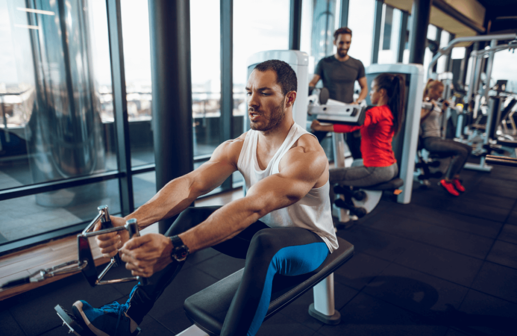 A man at the gym using a low row machine