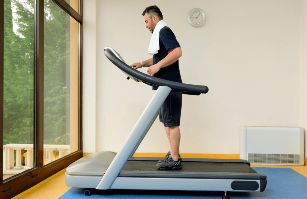 A man using the features of a treadmill type