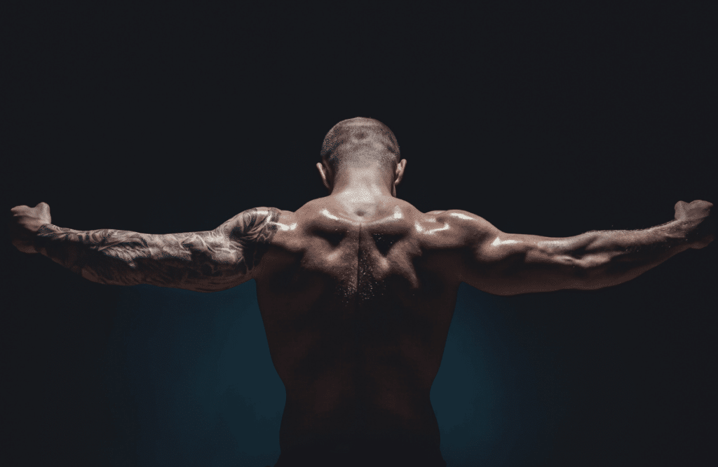 Un homme musclé montre les muscles de son dos