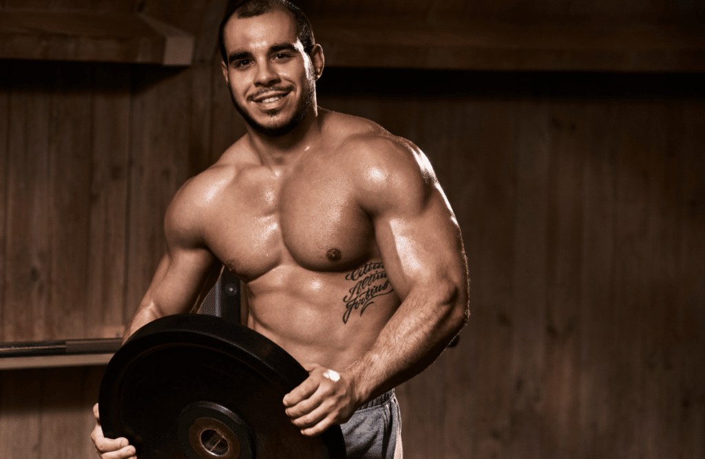 A man holding bumper plates before weightlifting