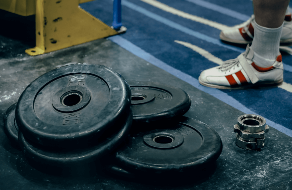 A bunch of bumper plates in a gym