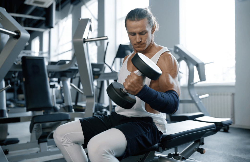 A man performing seated calf raises using a dumbbell