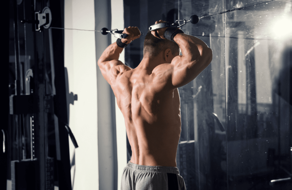 A man doing shoulder workout with a cable machine