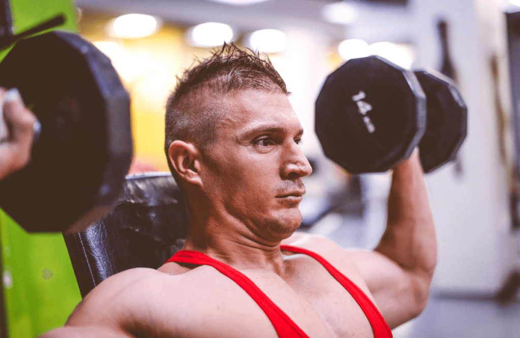 A man doing shoulder workout with dumbbells