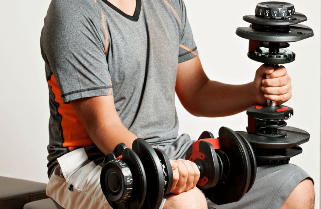 A man using 2 of the best adjustable dumbbells during a workout session