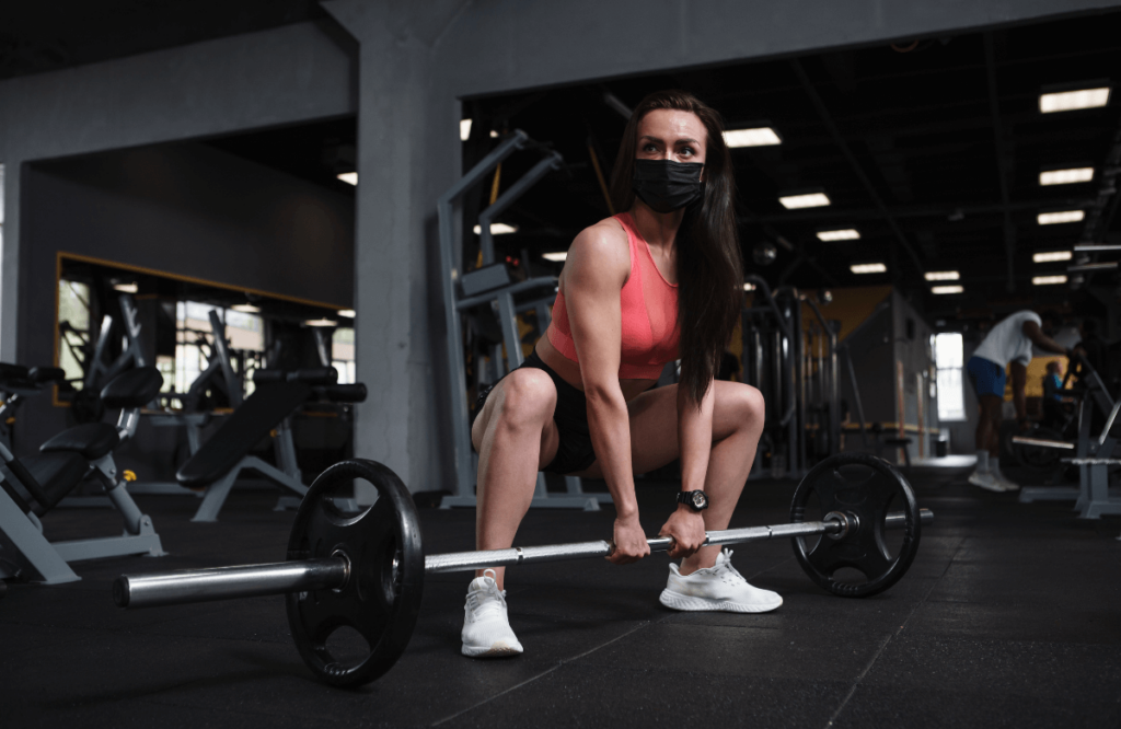 A woman doing sumo deadlifts