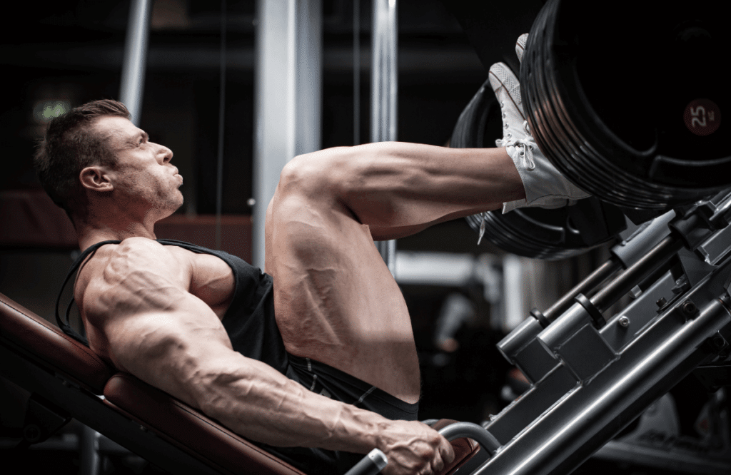 A musculat man using the leg press weight to increase muscle mass in the legs