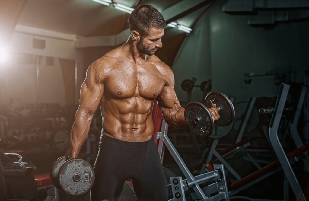 A muscular man working out with 2 dumbbells to reach 17-inch bicep size