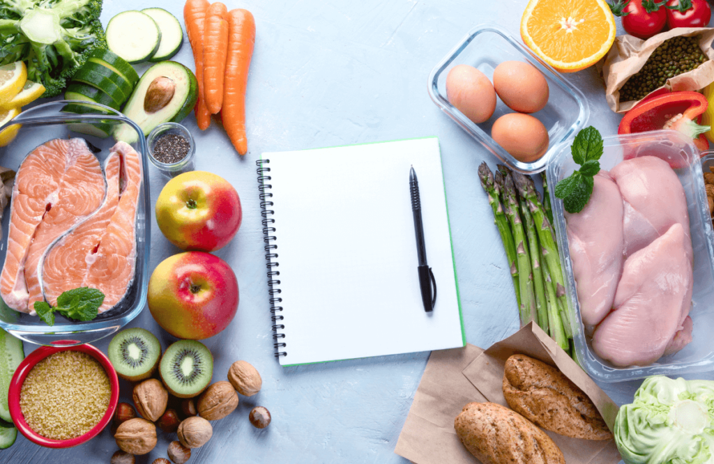 Someone scheduling his lean bulk meal plan on a notebook