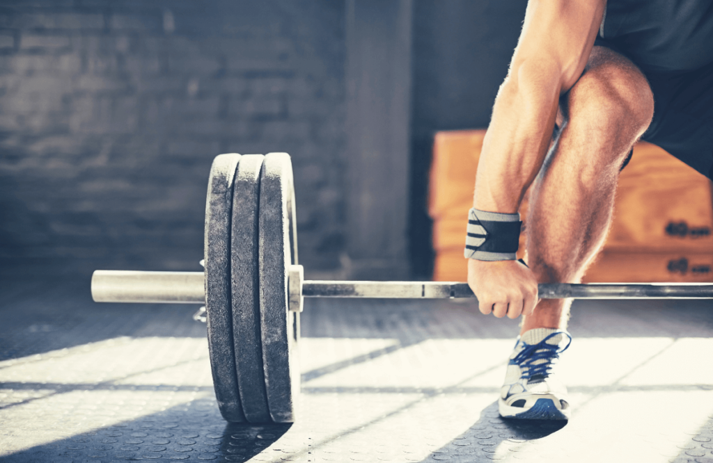 A man using a barbell to deadlift