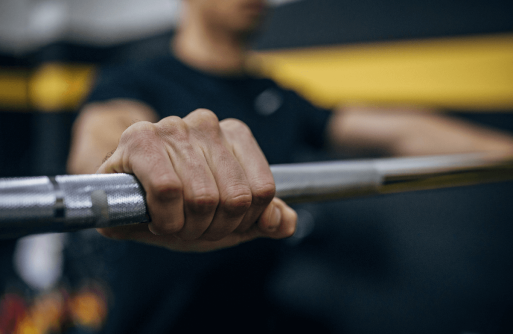 A man holding a standard barbell