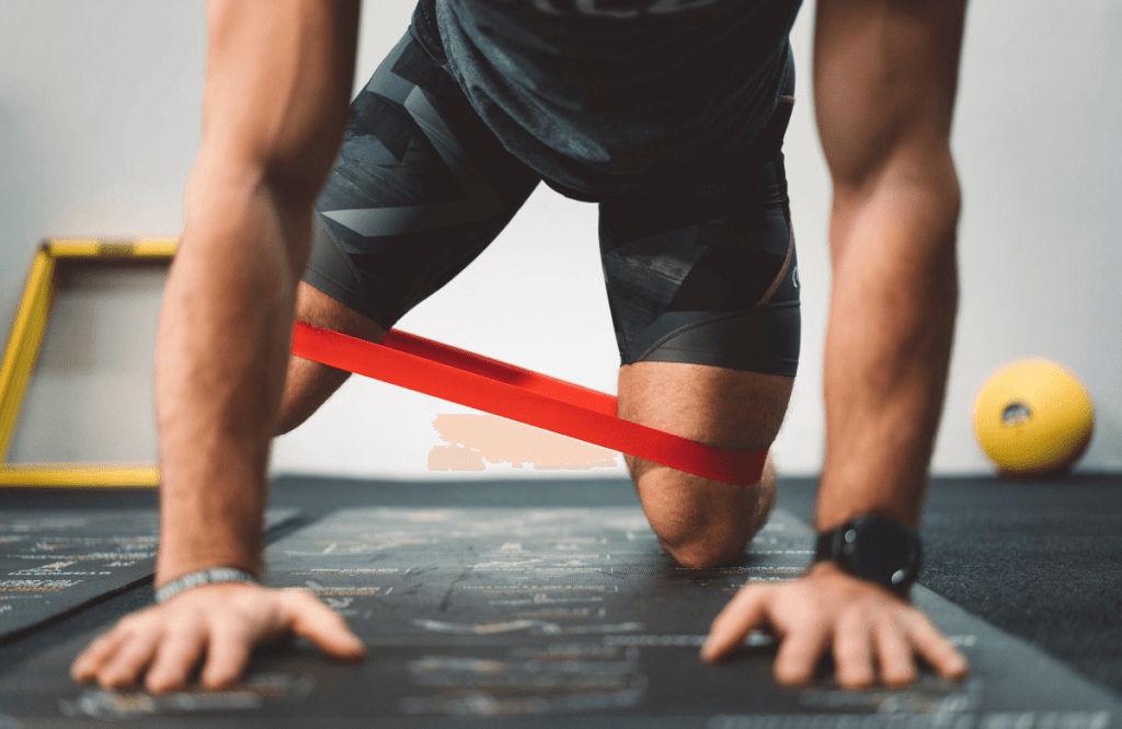A man performing resistance band leg workouts at the gym