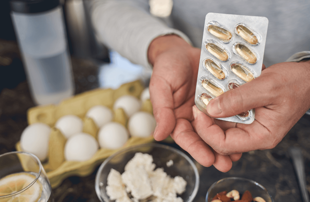 A woman taking pre-workout pills with her meal