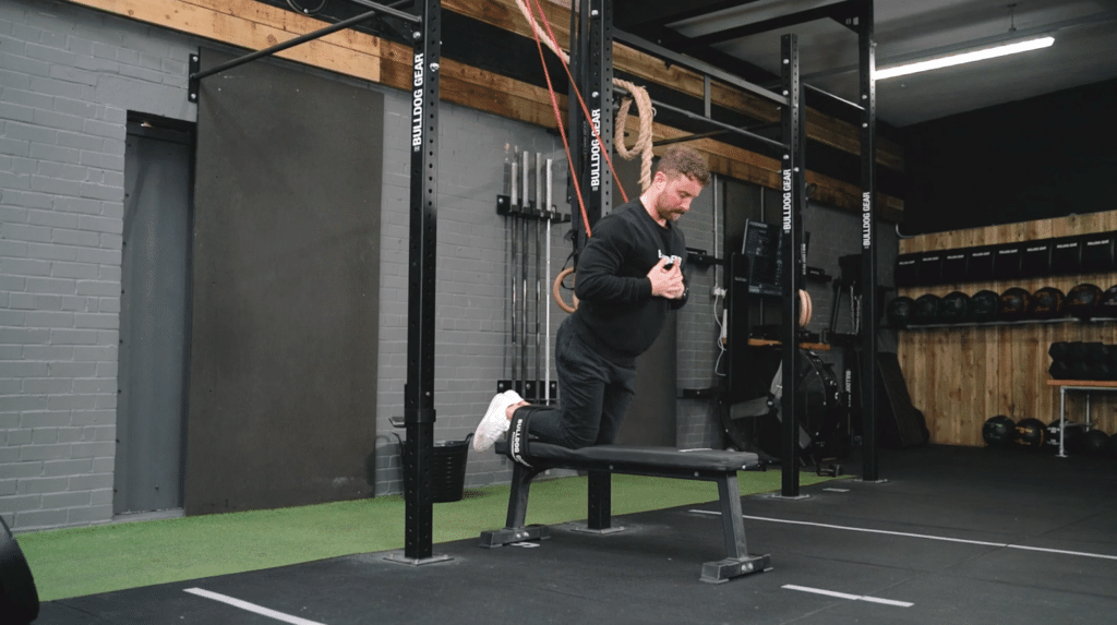 A man performing nordic curls to strengthen his hamstrings