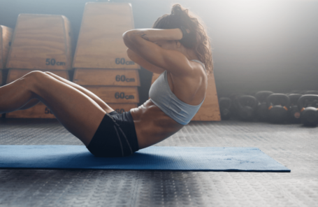 A woman performing the best lower abs exercises to get a six-pack quickly