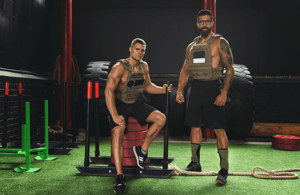 Two men wearing a CrossFit weighted vest during their workout