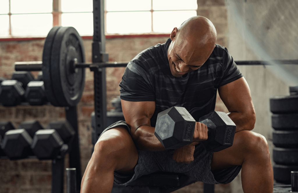 A man with veiny biceps working out with a dumbbell