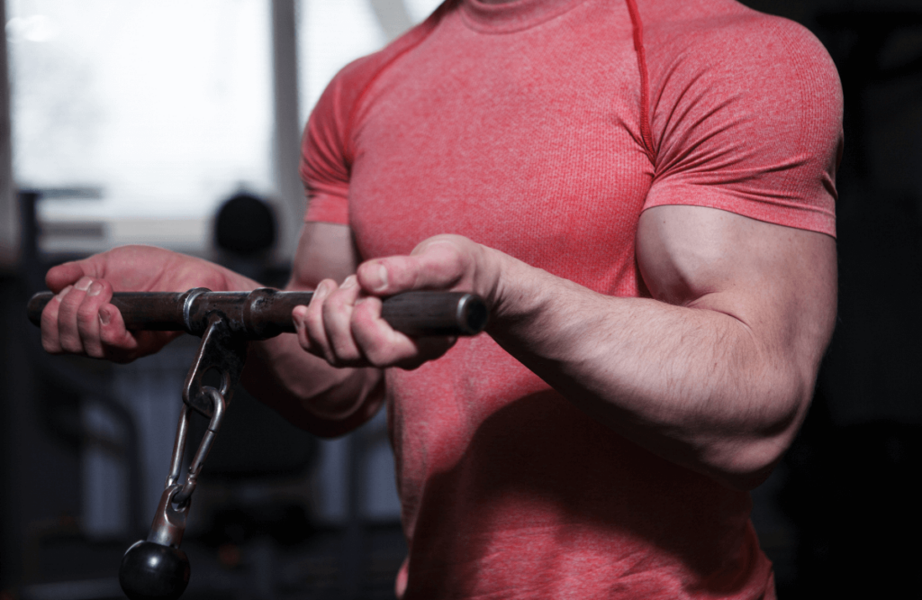 A man with veiny arms using a cable machine