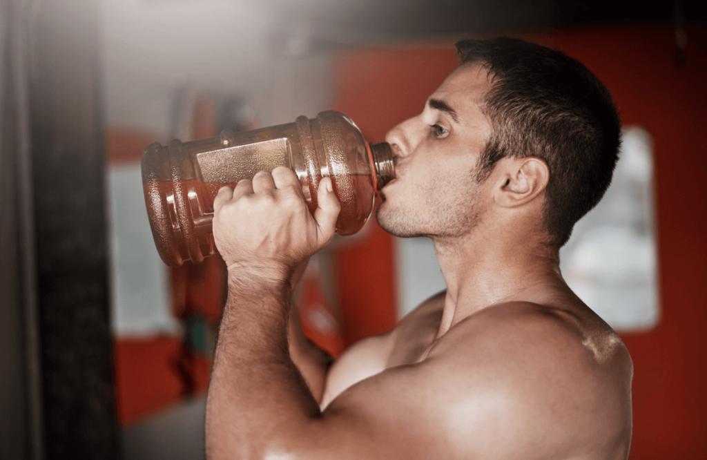 A man drinking a bottle of pre-workout he prepared