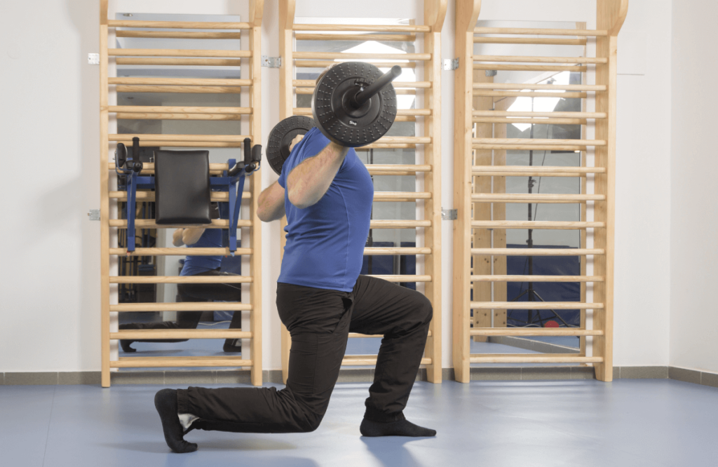 A man using the best safety squat bar at the gym