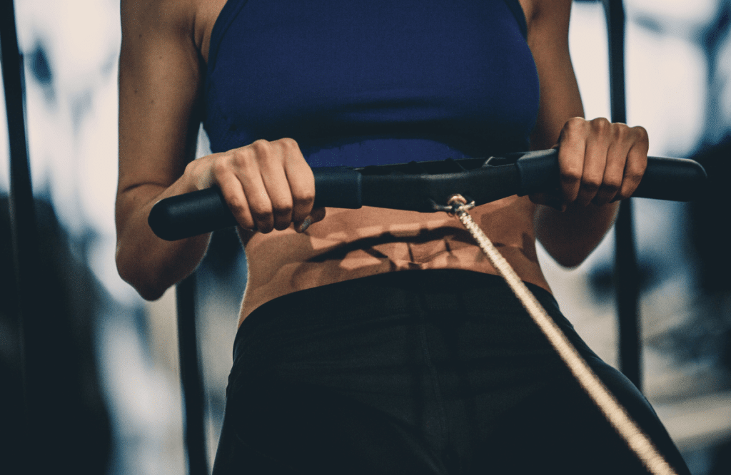 A woman during her rowing workout at the gym