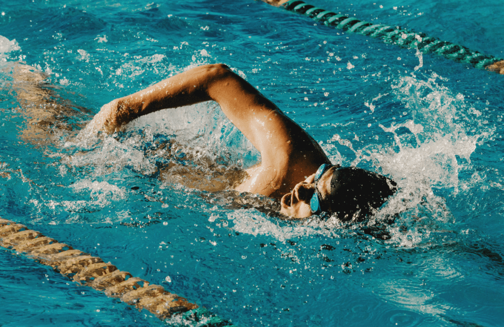 A man swimming during rest days of his full body workout