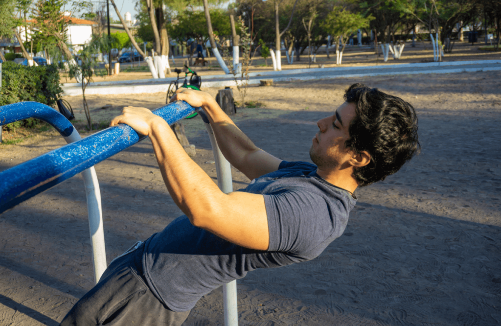 A man doing bodyweight exercises in a park