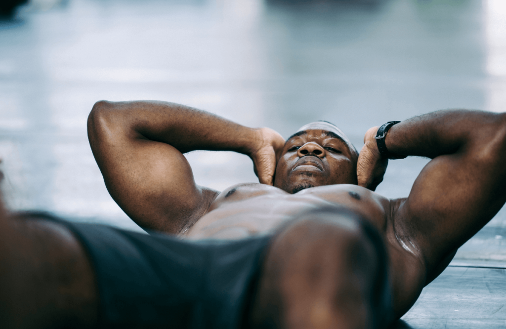 A man doing crunches at the gym in order to get a six-pack