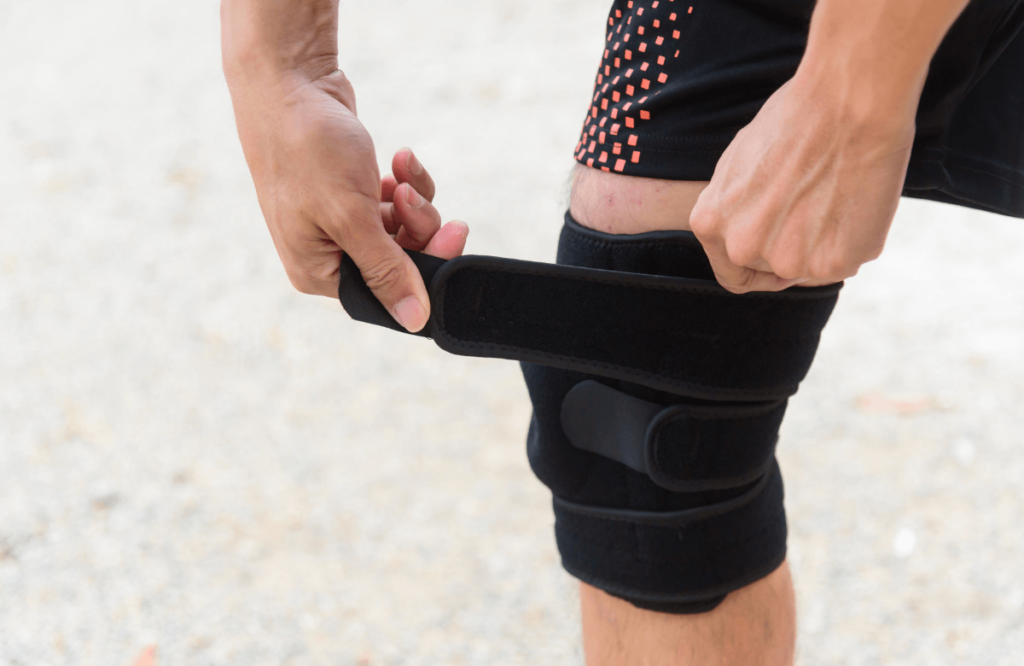 A man strapping a medical knee sleeve