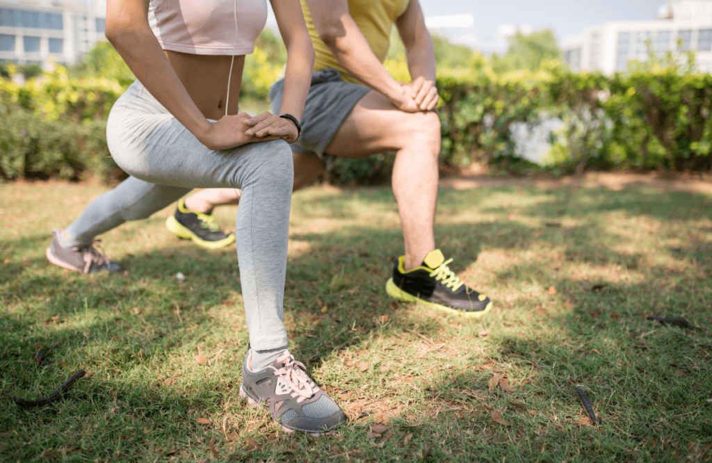 A couple stretching their quads