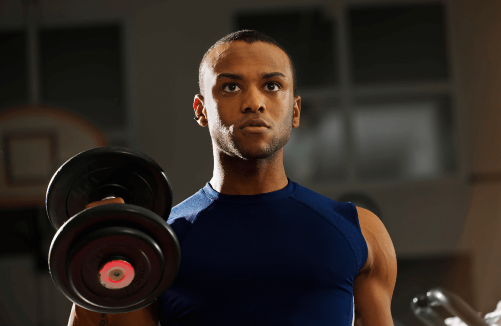 A man feeling the benefits of hammer curls in his body while exercising